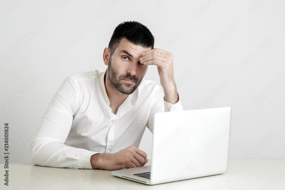 Studio portrait of young businessman in front of his laptop
Studio portrait of young businessman in front of his laptop