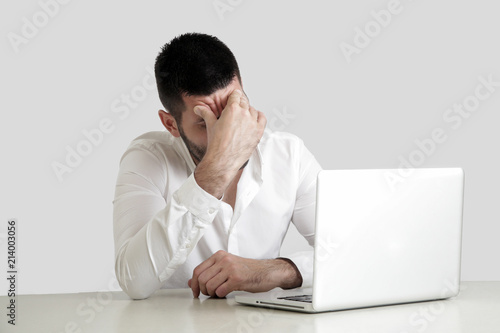 Office life - portrait of young businessman struggling with a project