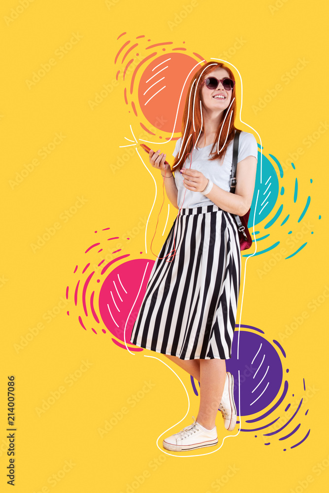 Bright place. Beautiful young girl wearing sunglasses and enjoying the music in her earphones while walking in a lovely park Bright place. Beautiful young girl wearing sunglasses and enjoying the music in her earphones while walking in a lovely park