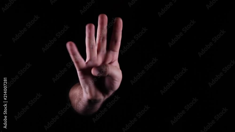 Hand Gestures coming out of the dark into the light. Holding GFX object. the number four. Hand Gestures coming out of the dark into the light. Holding GFX object. the number four.