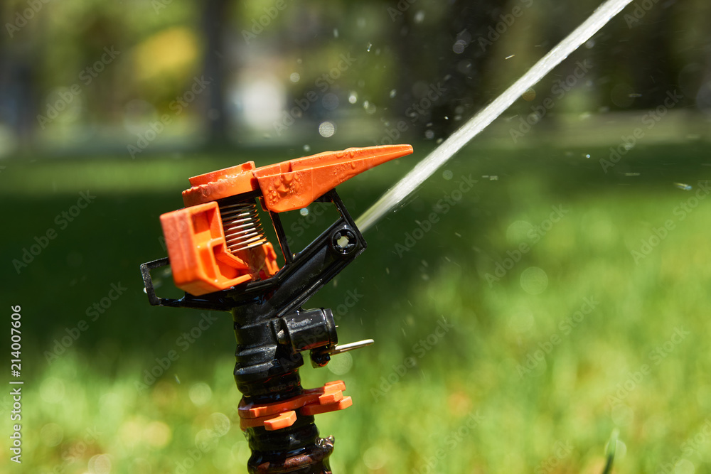 Close up sprinklers spraying water on grass lawn irrigation at early morning. Smart garden activated with full automatic watering. Eco irrigation system Close up sprinklers spraying water on grass lawn irrigation at early morning. Smart garden activated with full automatic watering. Eco irrigation system