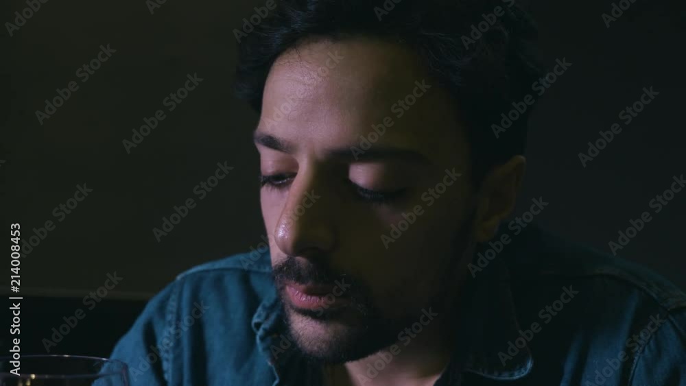 alcoholism, addiction. Depressed man drinks wine alone in the darkness alcoholism, addiction. Depressed man drinks wine alone in the darkness