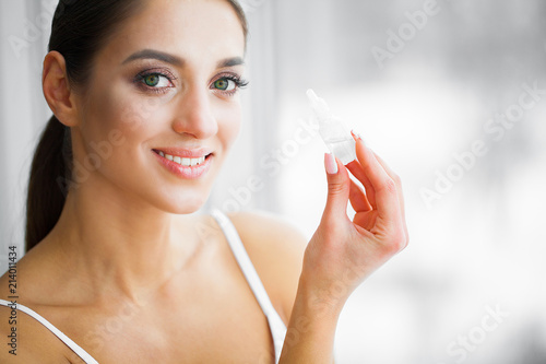 Health and Beauty. Eye Care. Beautiful Young Woman Holding Drops For Eyes. Good Vision. Happy Girl with Fresh Look