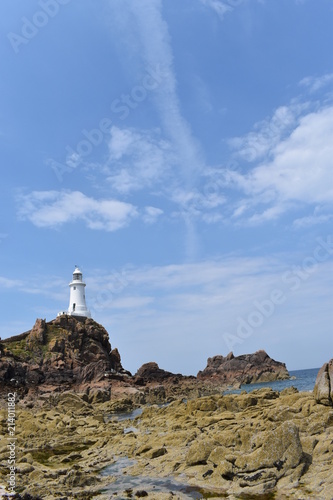 Escape the heatwave. Discover the iconic La Corbière lighthouse in Jersey. England, July