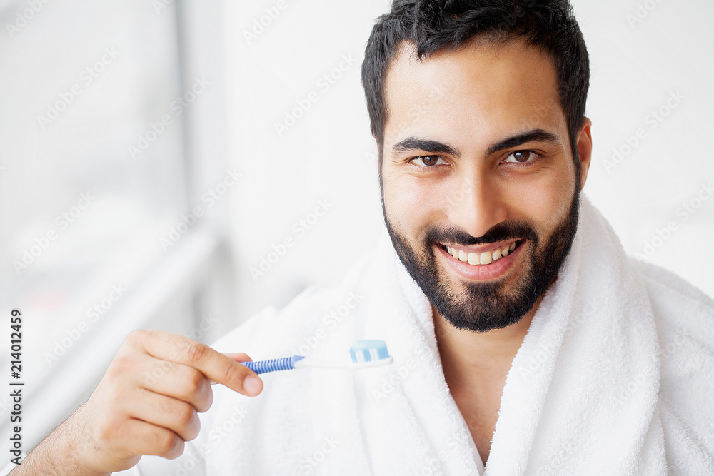 Beautiful Smiling Man Brushing Healthy White Teeth With Brush. High Resolution Image Beautiful Smiling Man Brushing Healthy White Teeth With Brush. High Resolution Image