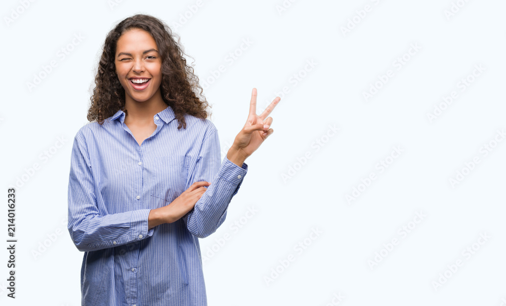 Young hispanic business woman smiling with happy face winking at the camera doing victory sign. Number two. Young hispanic business woman smiling with happy face winking at the camera doing victory sign. Number two.