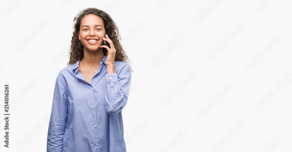 Young hispanic woman using smartphone with a happy face standing and smiling with a confident smile showing teeth