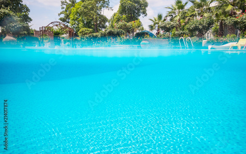 Over under water split shot in the swimming pool  blue spa swimming pool with clean water.