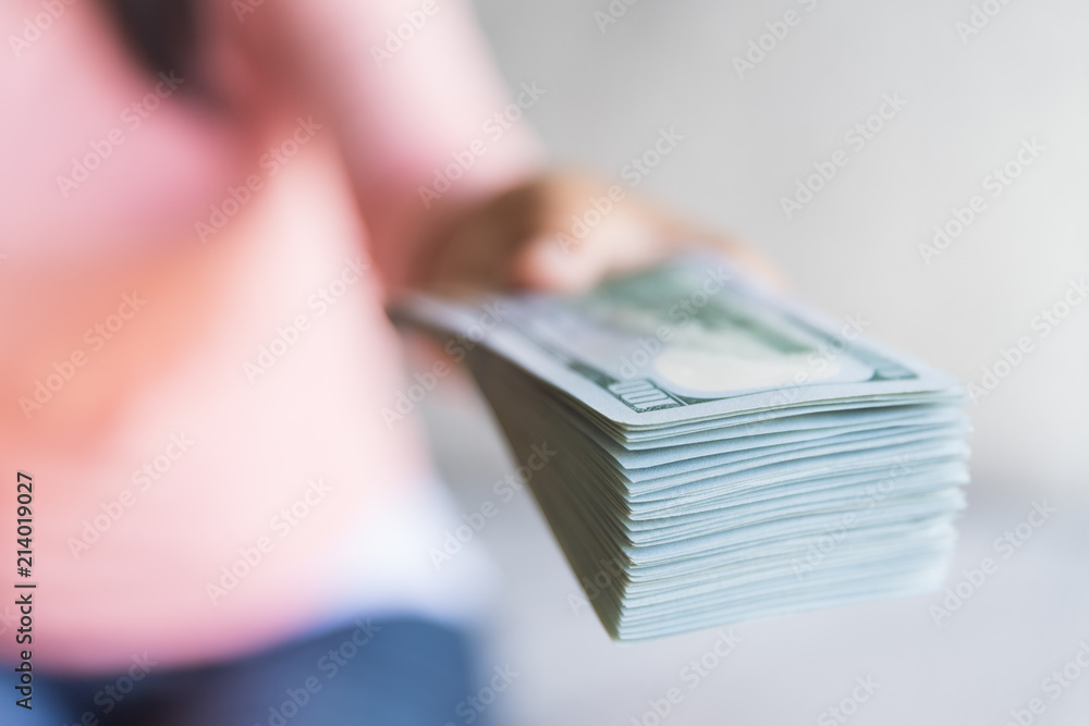 Soft focus on woman hands proposing money us dollar bills to you. Soft focus on woman hands proposing money us dollar bills to you.