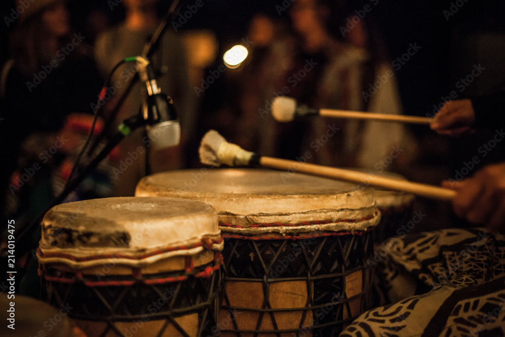 Drumsticks on djembe, recorded by a microphone during a live performance in front of a crowd