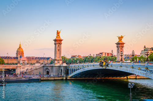 Beautiful sunset view on Pont Alexandre III and Les Invalides in Paris, France © Olena Zn