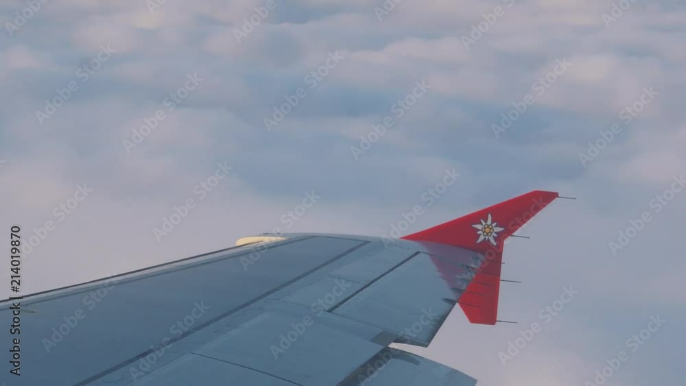 The View out of an Airplane flying above the Clouds and the snowy Mountains. The View out of an Airplane flying above the Clouds and the snowy Mountains.