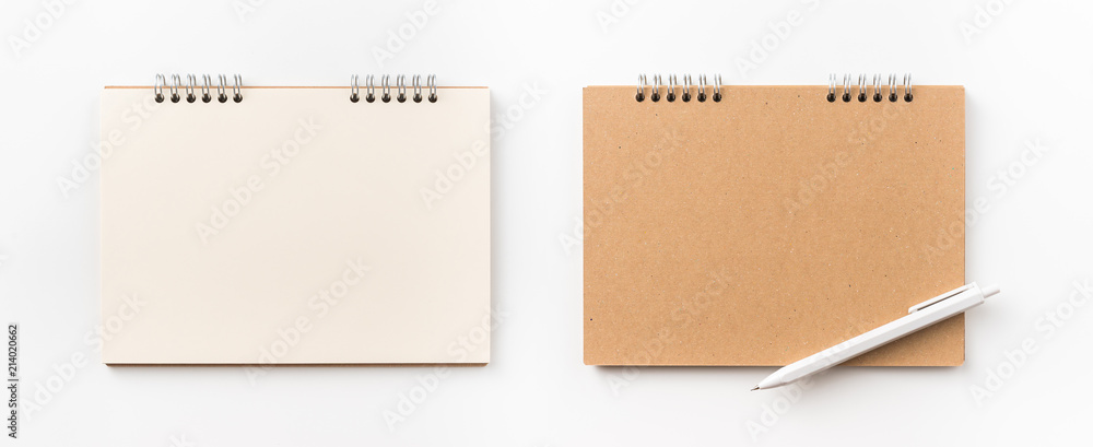 Design concept - Top view of kraft spiral notebook, blank page and pen isolated on white background for mockup Design concept - Top view of kraft spiral notebook, blank page and pen isolated on white background for mockup