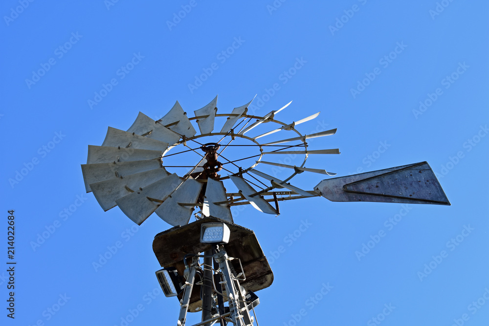 Metallic Windmill against Blue Sky