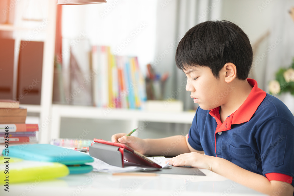 Asian preteens doing your homework with tablet. Asian preteens doing your homework with tablet.
