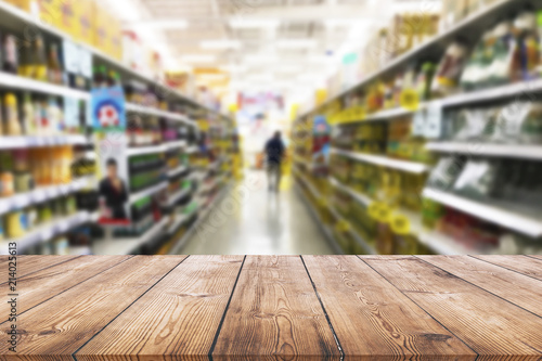 Empty wood table top on shelf in supermarket blurred background