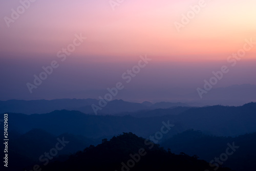 Mountains landscape under morning sky with dense fog. © yotrakbutda