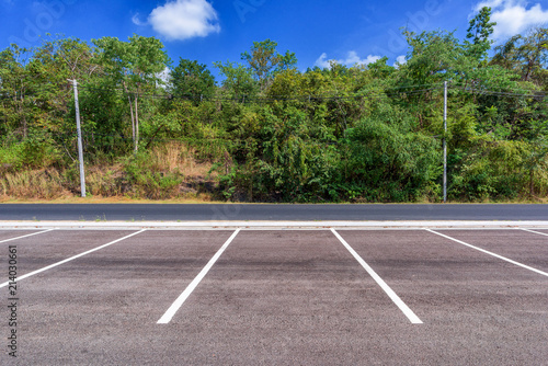 Empty parking lot with forest