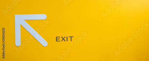Yellow exit sign, empty space.