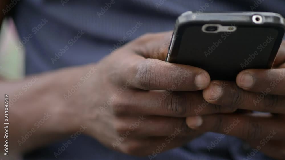 Mans'hand scrolling on smartphone in a restaurant Mans'hand scrolling on smartphone in a restaurant