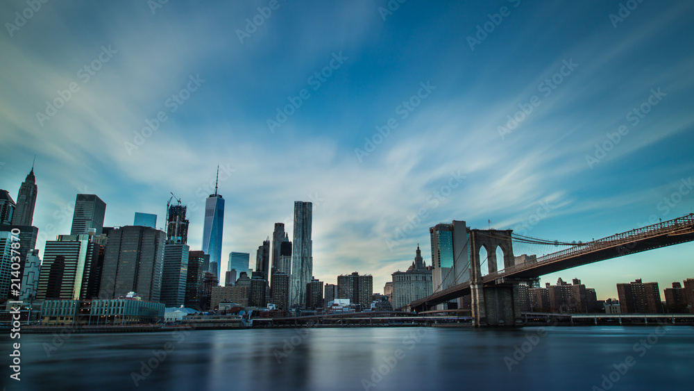 Manhattan skyline with Brooklyn Bridge shot at sunset