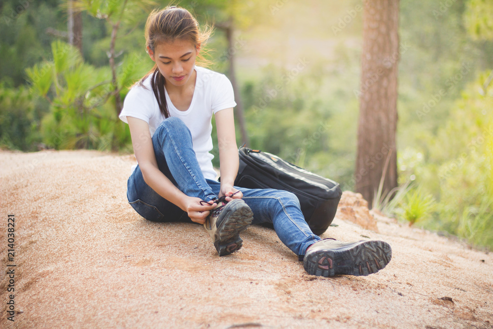 woman tying shoe laces, Closeup of female tourist getting ready for hiking, Hiking shoes . woman tying shoe laces, Closeup of female tourist getting ready for hiking, Hiking shoes .