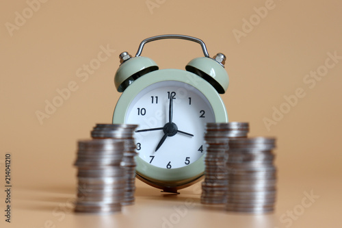 Piles of coins and an alarm clock.