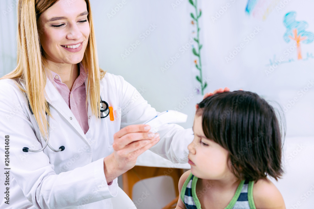 Pediatrician measuring temperature of a little boy Pediatrician measuring temperature of a little boy