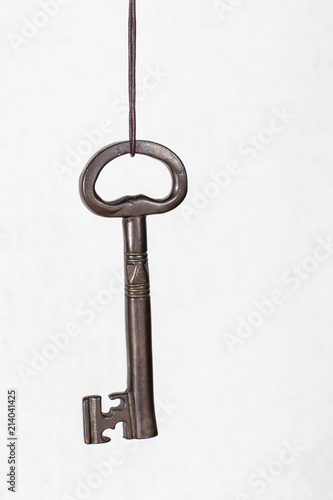 Big key hanging on a string, security concept © Eva