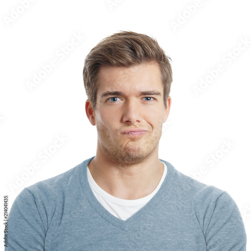 displeased or sceptical young man is making a face