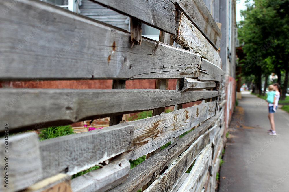 wooden fence is standing in the street children street