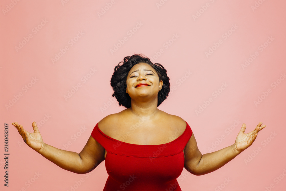 Life is wonderful/ Portrait of a confident, satisfied and happy woman with both hands out, isolated on pink - obrazy, fototapety, plakaty 