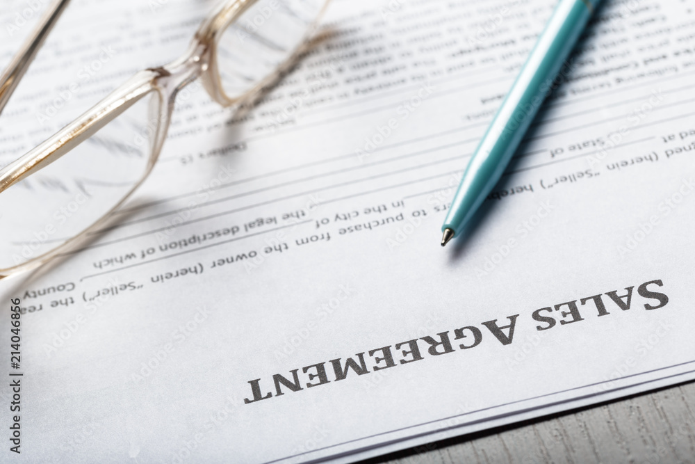 Close up shot of Eyeglasses on contract document papers business concept Close up shot of Eyeglasses on contract document papers business concept