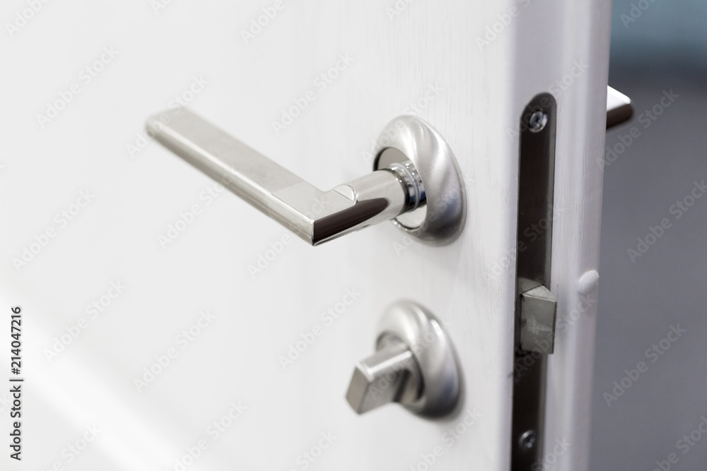 Detail of a metallic knob on white door horizontal Detail of a metallic knob on white door horizontal