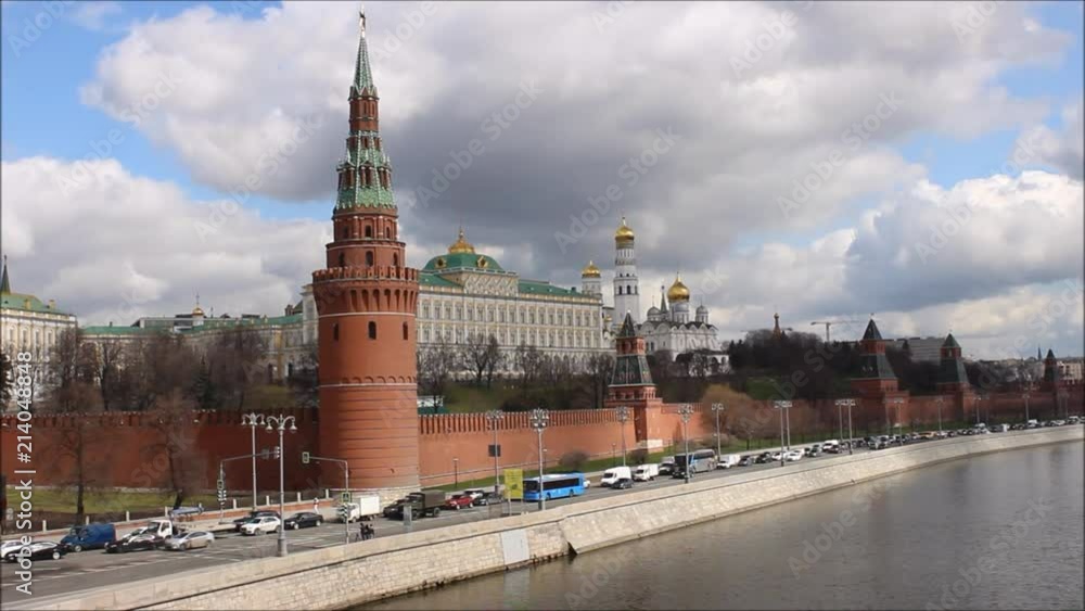 Russia, Moscow, center - view from the Big stone bridge on the Kremlin wall, the Church with Golden domes, towers of red square, traffic on the Kremlin quay in the spring against the cloudy sky Russia, Moscow, center - view from the Big stone bridge on the Kremlin wall, the Church with Golden domes, towers of red square, traffic on the Kremlin quay in the spring against the cloudy sky