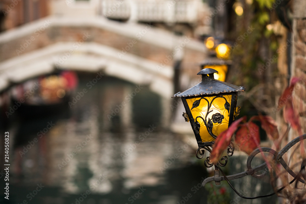 Detail of lamp in a Venice canal with blurred background Detail of lamp in a Venice canal with blurred background