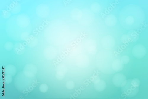 Pale turquoise green blurred background with bokeh lights