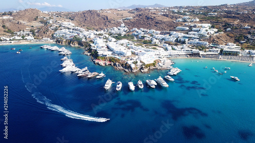 Aerial drone photo of luxury speed boats docked in popular beach of Psarou with iconic resorts, Mykonos island, Cyclades photo