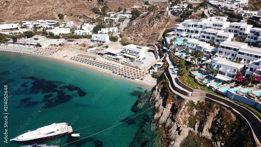 Obraz premium Aerial drone photo of famous turquoise clear water beach of Psarou in iconic island of Mykonos, Cyclades, Greece