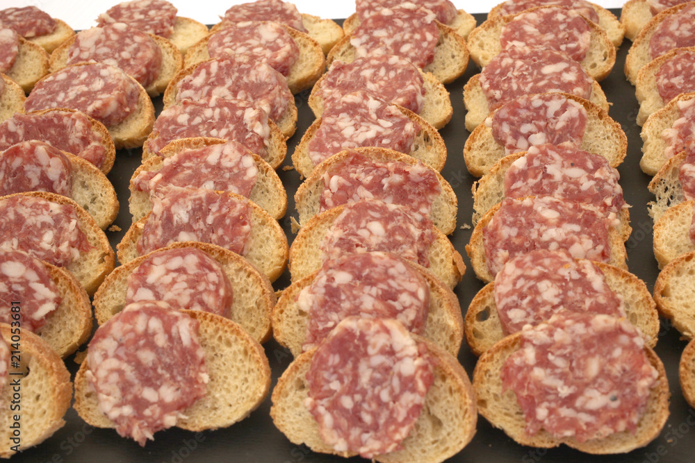 tray full of finger food bread with salami