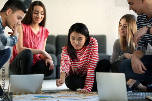 Diverse young adults collab...