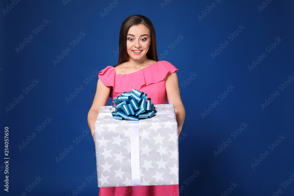 Beautiful young woman with big gift box on color background Beautiful young woman with big gift box on color background