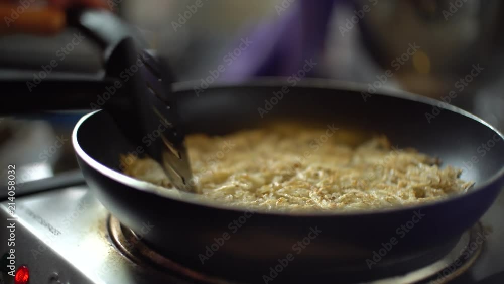 Homemade hashbrowns are prepared in a kitchen. Homemade hashbrowns are prepared in a kitchen.