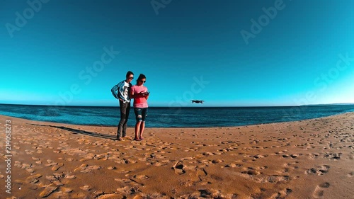 Two Girls Launching Drone On The Beach