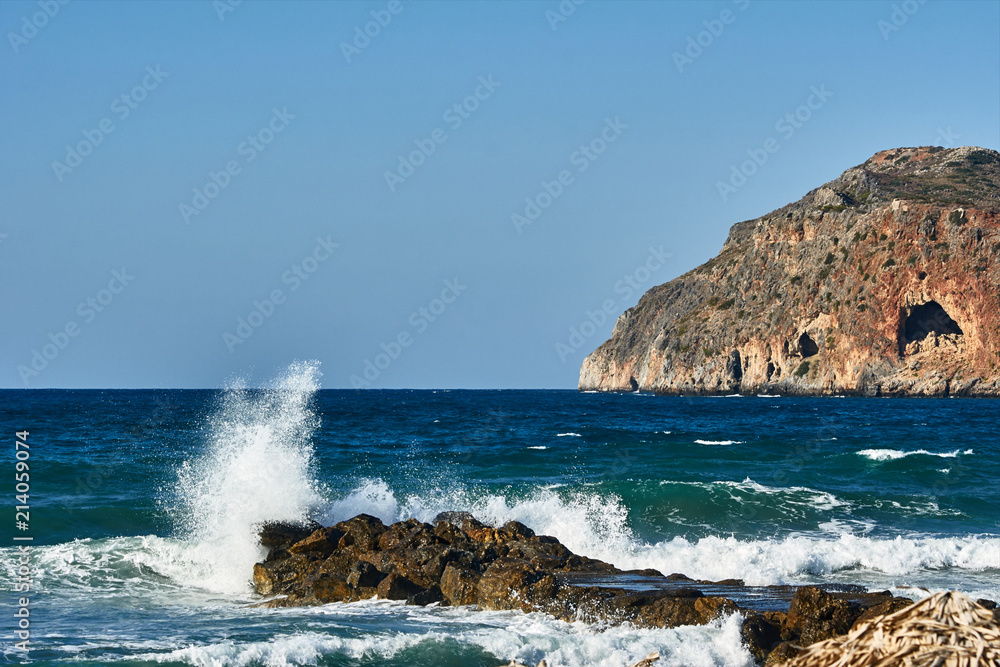 breakwater and Theodore island off the coast of Crete, Greece.