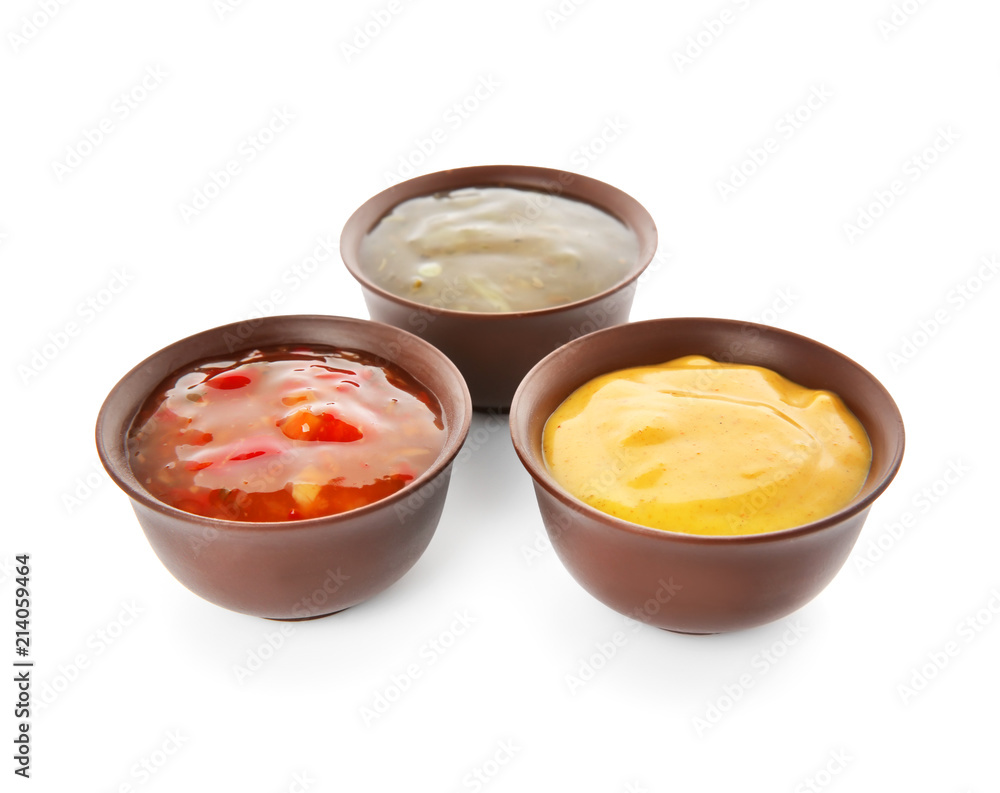 Bowls with different sauces on white background Bowls with different sauces on white background