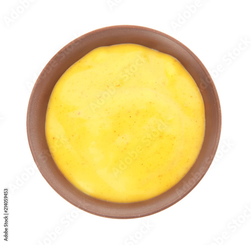 Bowl with curry sauce on white background, top view