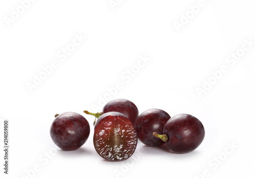 Cardinal grapes with halved slice isolated on white background