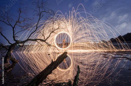 firework swing fire on dead tree fourground  photo