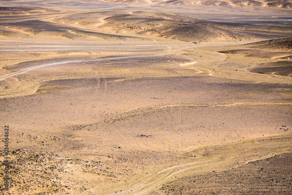 Fototapeta premium Volcanic black basalt terrain in Sahara desert in Morocco